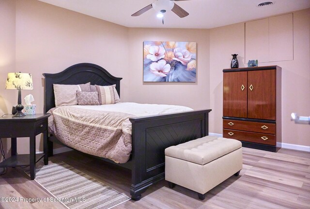 bedroom with ceiling fan and light hardwood / wood-style flooring