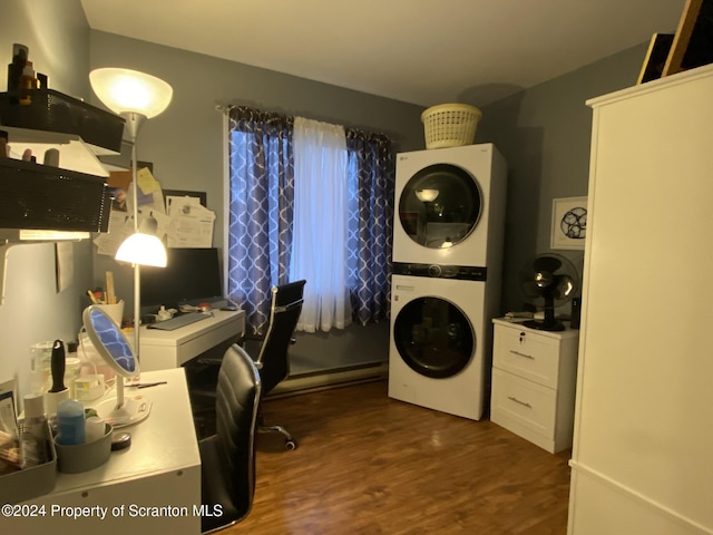 office featuring dark hardwood / wood-style flooring, a baseboard radiator, and stacked washer and clothes dryer