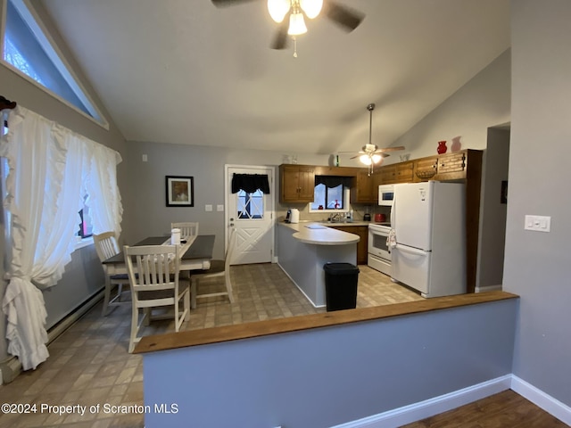 kitchen featuring kitchen peninsula, white appliances, vaulted ceiling, and ceiling fan