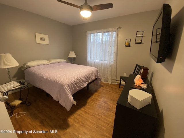 bedroom featuring hardwood / wood-style flooring and ceiling fan