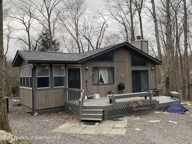 view of front of property with a sunroom and a deck