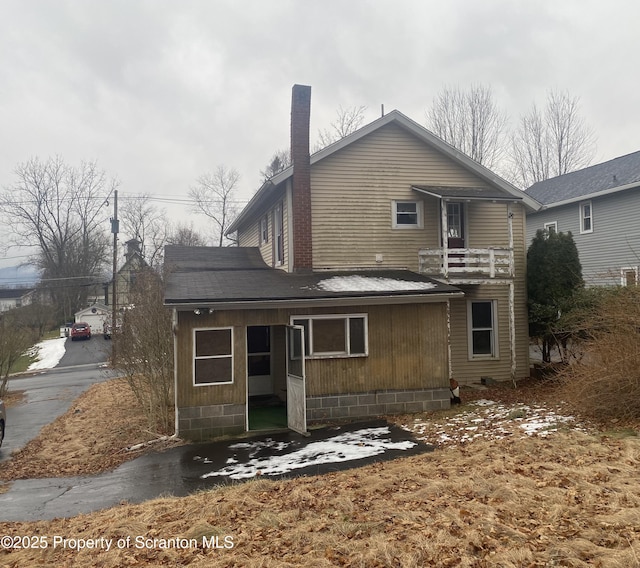 rear view of house featuring a balcony