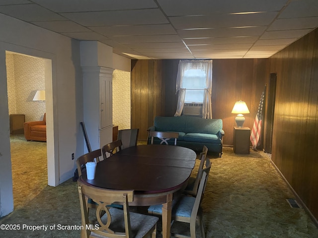 dining room with carpet floors, cooling unit, and wooden walls