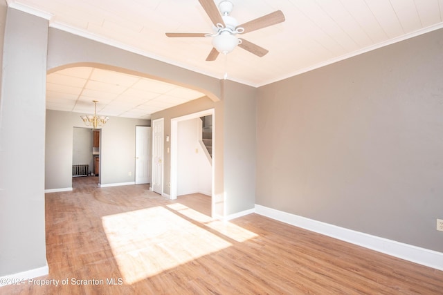 empty room with ceiling fan with notable chandelier, hardwood / wood-style flooring, radiator, and crown molding