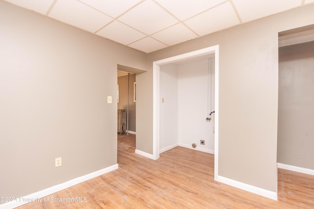 unfurnished room featuring a paneled ceiling and light hardwood / wood-style floors