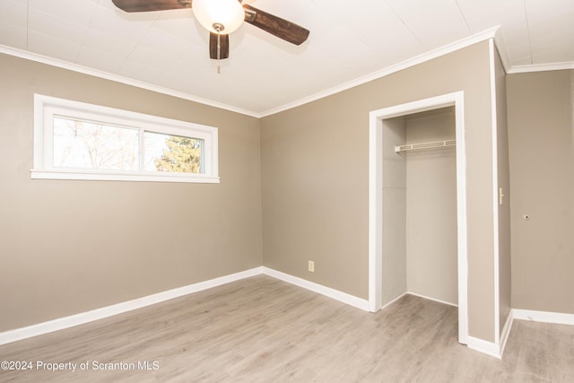 unfurnished bedroom with ceiling fan, a closet, ornamental molding, and light hardwood / wood-style flooring