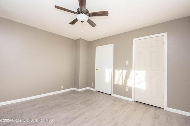 unfurnished bedroom featuring ceiling fan and light wood-type flooring