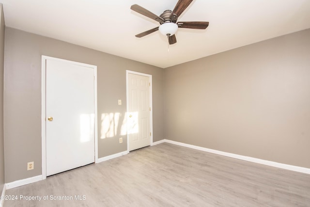 unfurnished bedroom with light wood-type flooring and ceiling fan