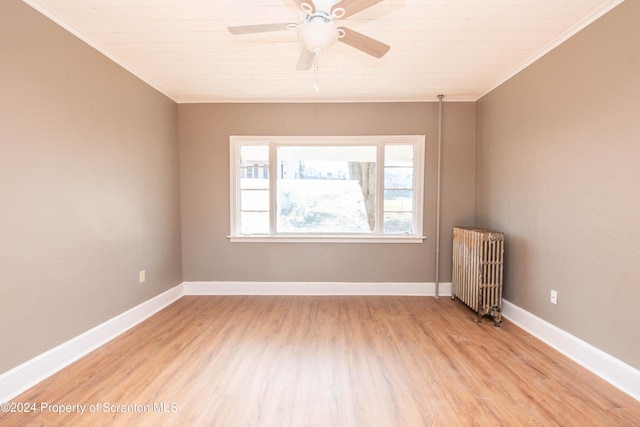 unfurnished room featuring ceiling fan, light hardwood / wood-style floors, radiator heating unit, and ornamental molding