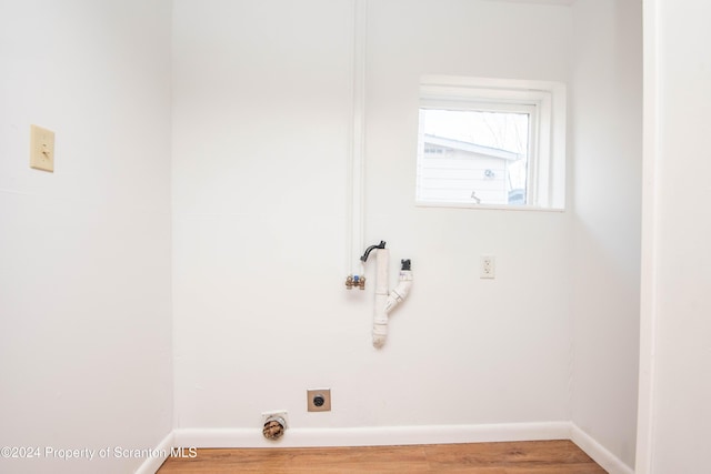 laundry room with hookup for an electric dryer and hardwood / wood-style flooring