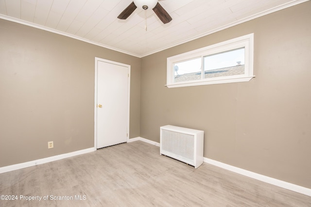 spare room with ceiling fan, radiator heating unit, crown molding, and light hardwood / wood-style flooring