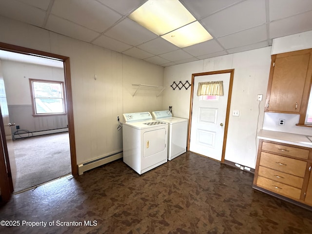 washroom with a baseboard radiator and washer and clothes dryer