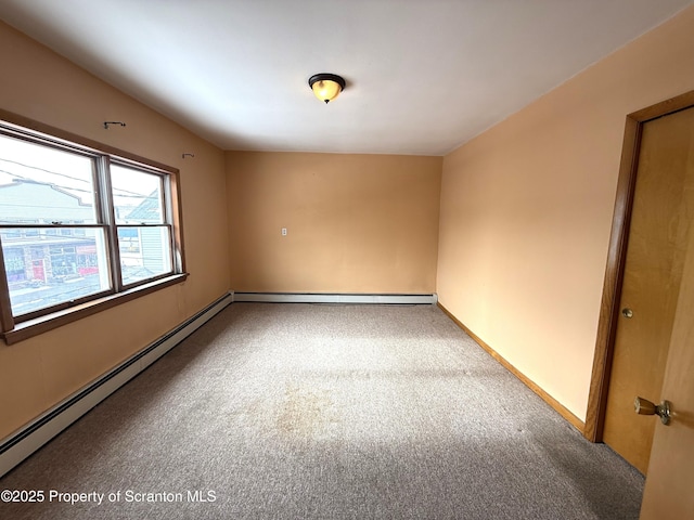 carpeted empty room featuring baseboard heating