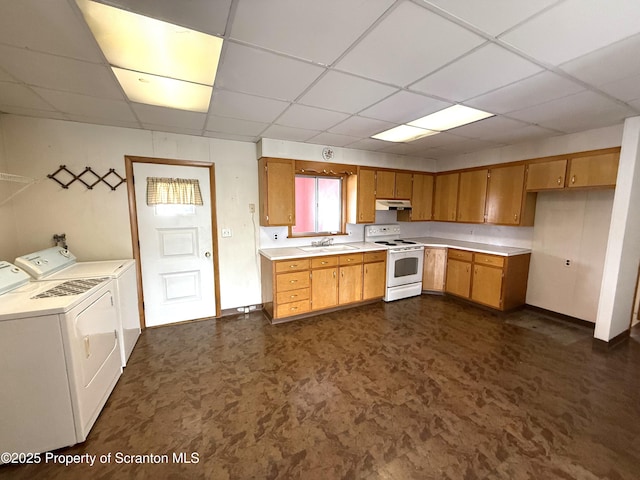 kitchen with white electric range oven, sink, a drop ceiling, and washing machine and clothes dryer