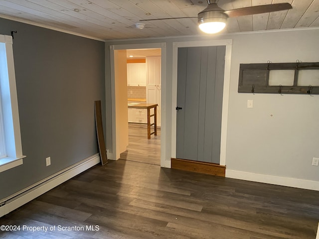 spare room with baseboard heating, crown molding, dark wood-type flooring, and wooden ceiling