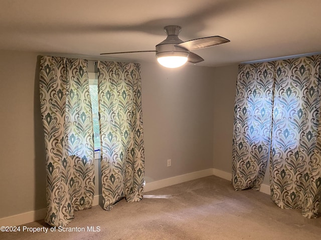 empty room with carpet flooring and ceiling fan