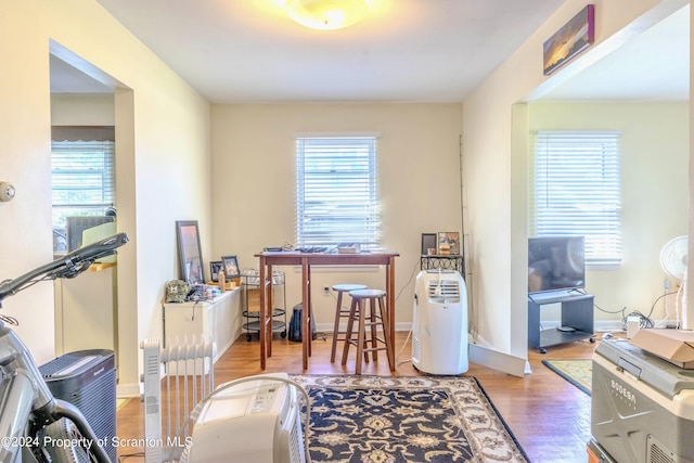 home office with hardwood / wood-style flooring