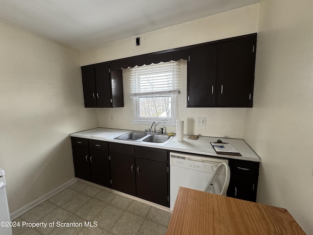 kitchen featuring white dishwasher and sink