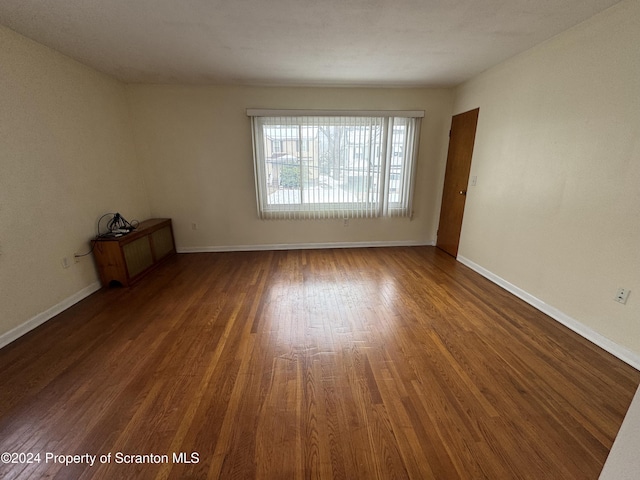 spare room with wood-type flooring