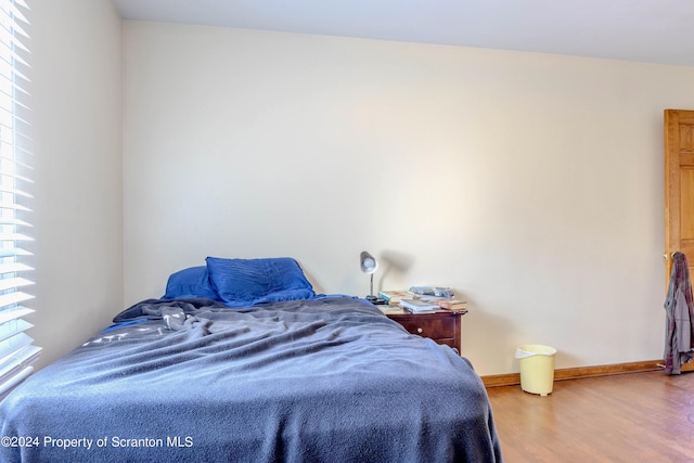 bedroom with hardwood / wood-style flooring