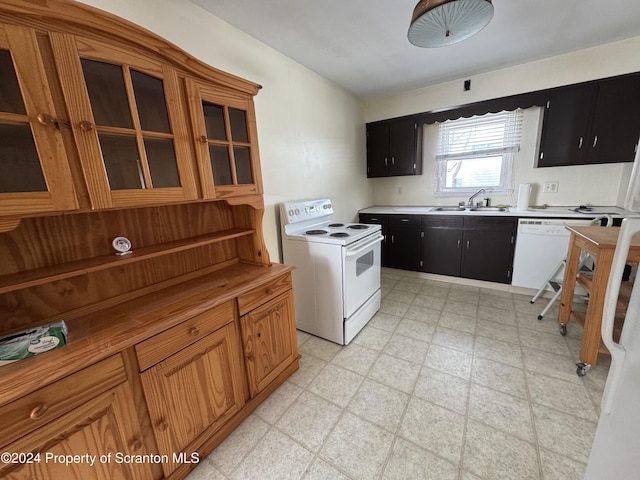 kitchen featuring white appliances and sink