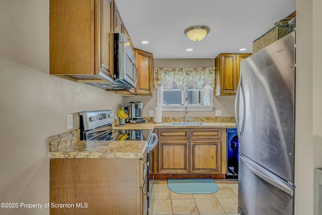 132 6th St, Blakely, PA 18447 - kitchen featuring stainless steel appliances, brown cabinetry, light countertops, and recessed lighting