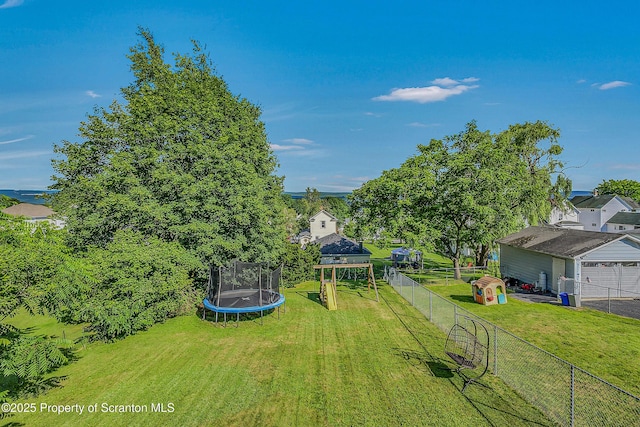132 6th St, Blakely, PA 18447 - view of yard featuring a trampoline and a garage