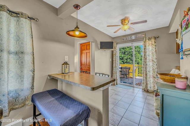 132 6th St, Blakely, PA 18447 - kitchen with light tile patterned floors, ceiling fan, a peninsula, decorative light fixtures, and a kitchen bar