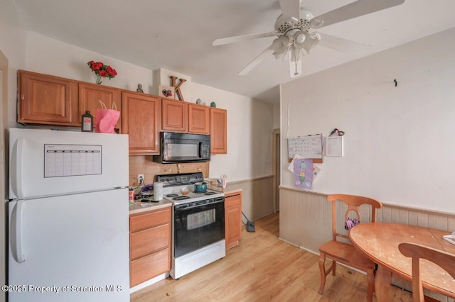 1116 Rock St Rear, Rear, Scranton, PA 18504 - kitchen featuring freestanding refrigerator, black microwave, electric range, light wood-style floors, and a ceiling fan