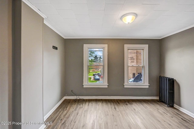 1014 Jackson St 1012, Scranton, PA 18504 - unfurnished room with radiator heating unit, ornamental molding, and wood finished floors