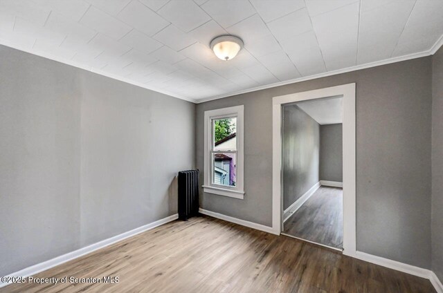 1014 Jackson St 1012, Scranton, PA 18504 - empty room featuring radiator, ornamental molding, and wood finished floors