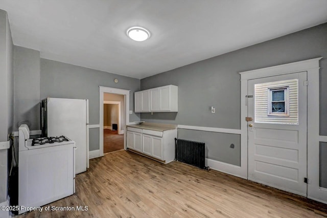 1014 Jackson St 1012, Scranton, PA 18504 - kitchen featuring radiator, white appliances, light wood-type flooring, white cabinetry, and light countertops
