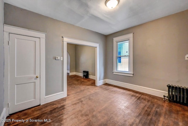 1014 Jackson St 1012, Scranton, PA 18504 - empty room with radiator heating unit and wood finished floors