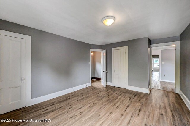 1014 Jackson St 1012, Scranton, PA 18504 - unfurnished bedroom with wood finished floors and a closet