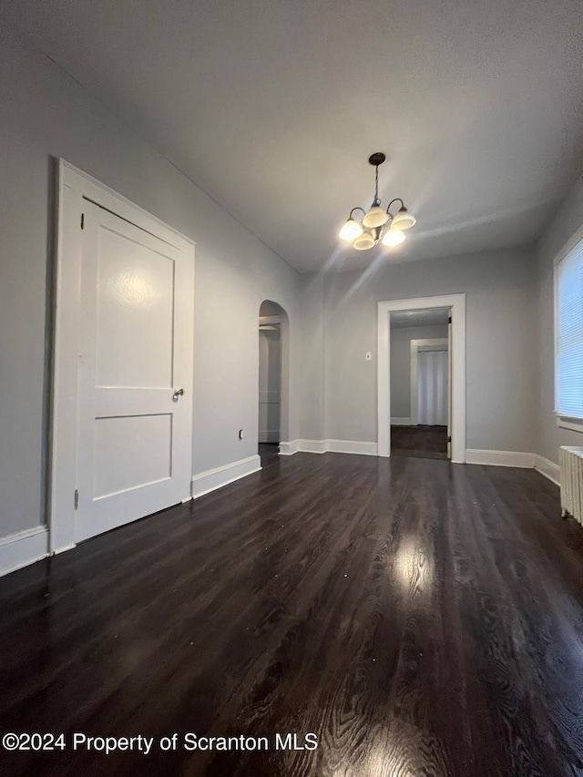 interior space with dark hardwood / wood-style flooring and an inviting chandelier