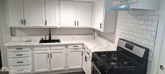 kitchen with black gas range, ventilation hood, white cabinetry, and sink