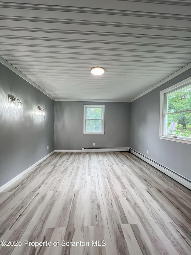 1446 Main St, Friendsville, PA 18818 - empty room with ornamental molding, baseboard heating, wood finished floors, and baseboards