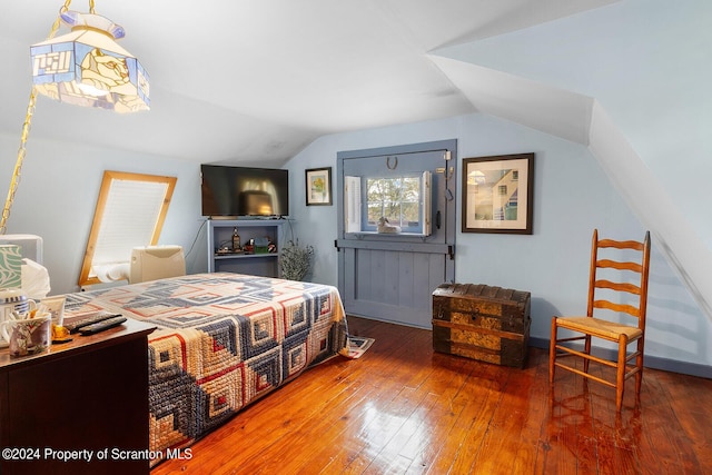 bedroom featuring hardwood / wood-style floors and lofted ceiling