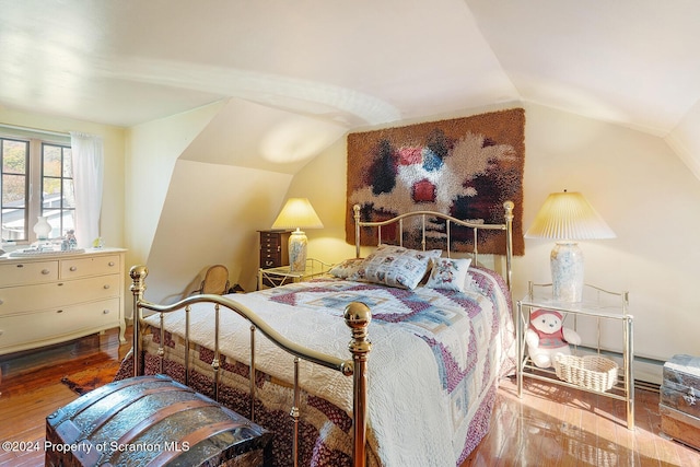 bedroom with wood-type flooring and lofted ceiling