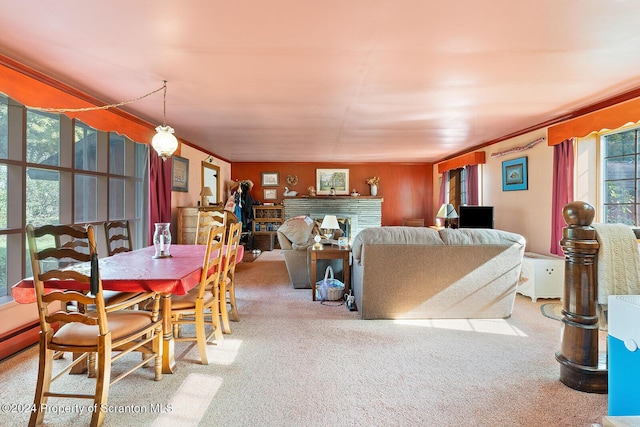 dining space with carpet floors and crown molding