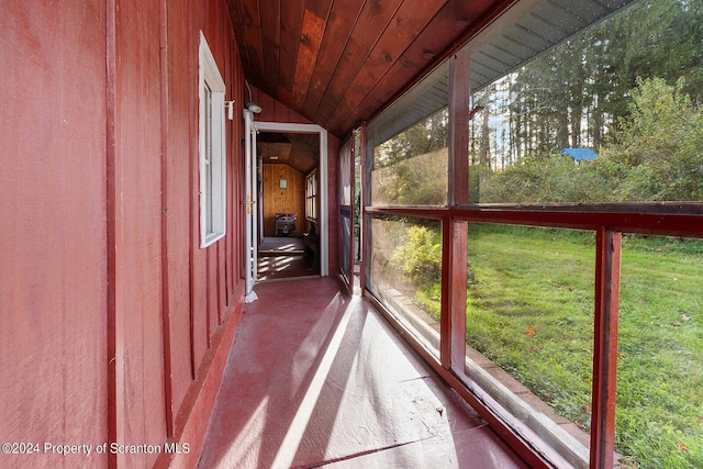 unfurnished sunroom featuring vaulted ceiling and wooden ceiling