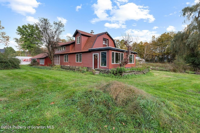 view of side of home featuring a yard