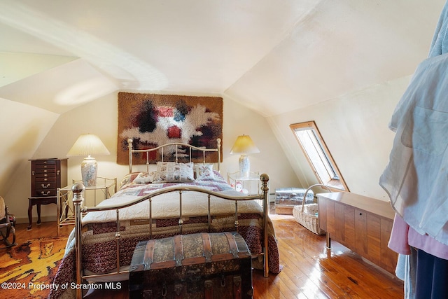 bedroom featuring wood-type flooring and lofted ceiling