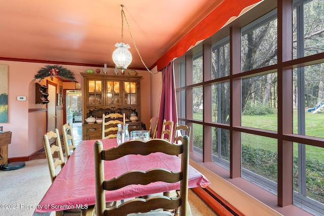 dining area featuring light carpet and an inviting chandelier