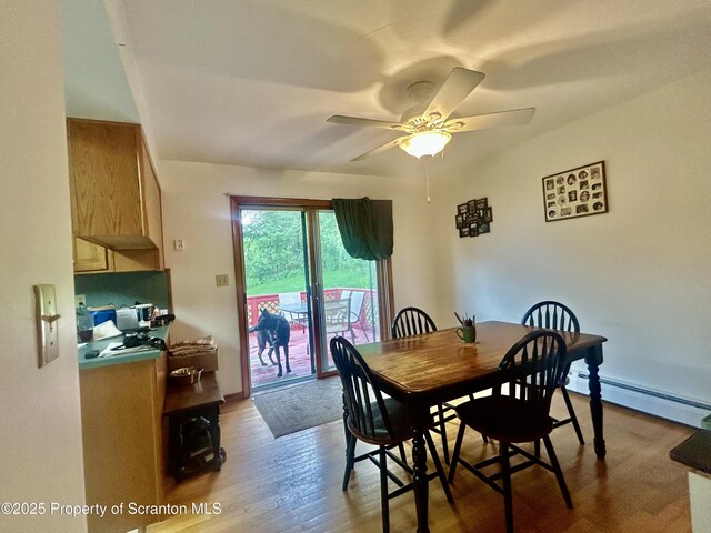 13 Mundro Rd, Scott Twp, PA 18447 - dining space with a baseboard heating unit, wood finished floors, and a ceiling fan