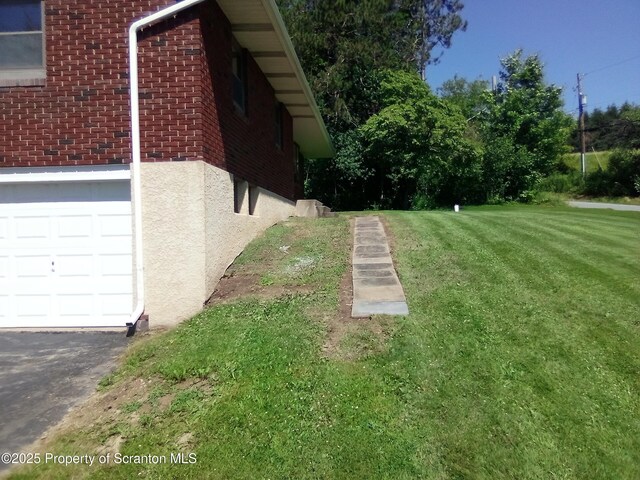 13 Mundro Rd, Scott Twp, PA 18447 - view of home's exterior featuring brick siding, a yard, and driveway