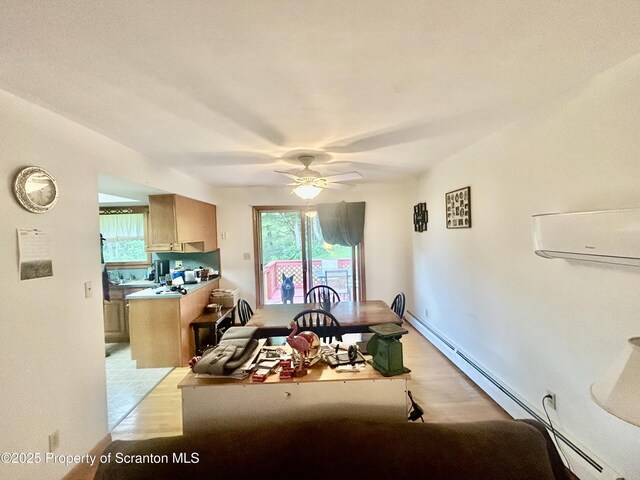 13 Mundro Rd, Scott Twp, PA 18447 - dining space with a baseboard radiator, a wall unit AC, light wood finished floors, ceiling fan, and healthy amount of natural light