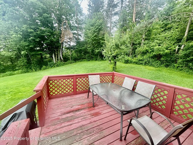 13 Mundro Rd, Scott Twp, PA 18447 - wooden deck with outdoor dining space, a lawn, and view of scattered trees