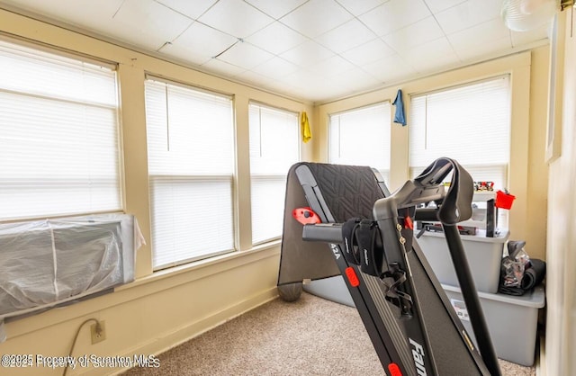 workout room featuring carpet floors and baseboards