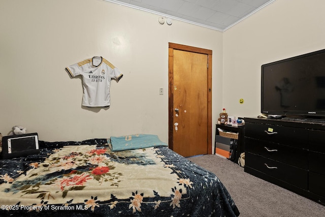 carpeted bedroom with ornamental molding